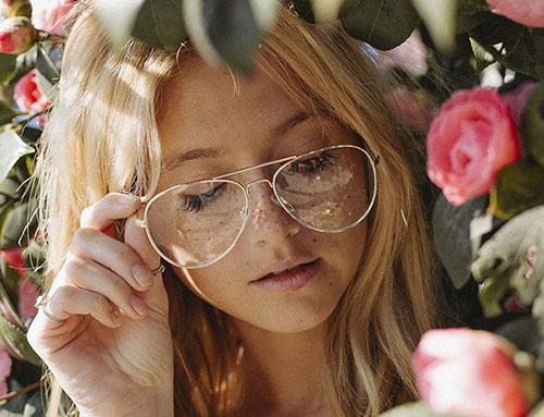 mujer con flores y lentes